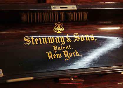 Antique, Steinway upright piano manufacturers logo on fall Antique, Steinway Upright Piano for sale.