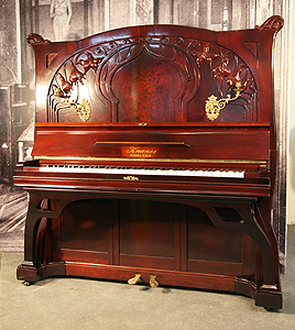 A 1914, Art Nouveau, Knauss upright piano with a mahogany case with carved flowers and tendrils