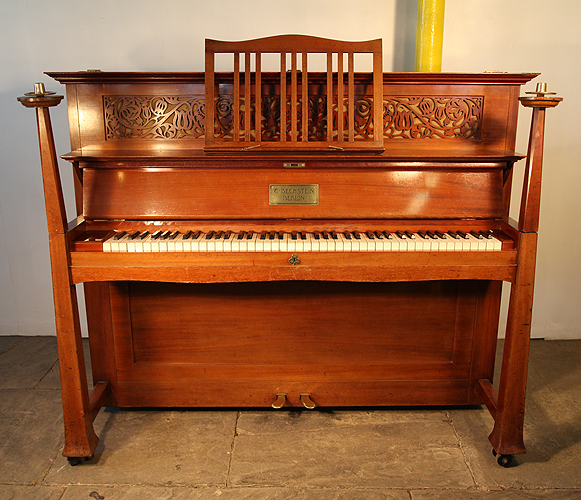 Arts and Crafts,1901, Bechstein upright pano with a mahogany case. Case features sculptural candlesticks, a fretwork panel and ornate brass hinges. Designed by Walter Cave, English Architect and Interior Designer