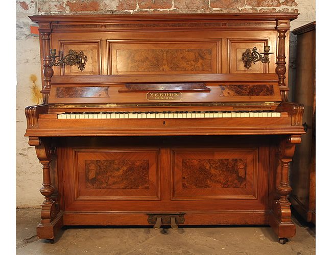 A 1900, Berdux upright piano with a walnut case, carved pilasters and burr walnut panels