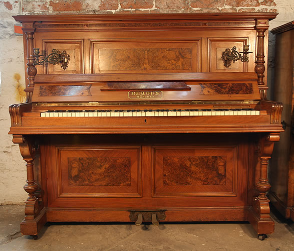 A 1900, Berdux upright piano with a walnut case, carved pilasters and burr walnut panels