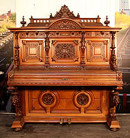 Oscar Gerbstadt Upright Piano For Sale with an Ornately Carved, Romanesque Style Case. Entire Cabinet is Covered with Carvings of Female Warriors, Lion's Heads, Fish, Corinthian Pillars, Oak and Acanthus Leaves