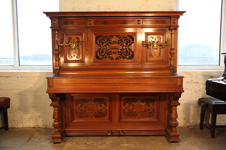 Steingraeber upright piano with an ornately carved, walnut case 