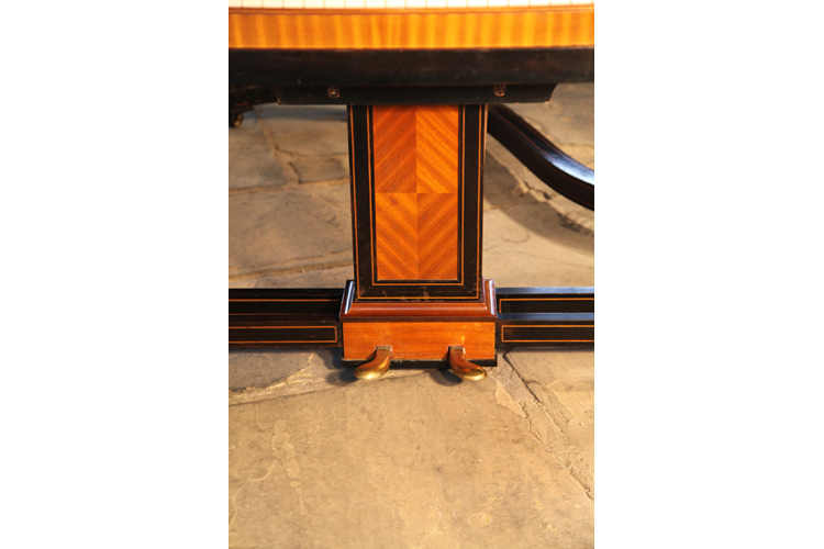 Steinway two-pedal piano lyre with geometric mahogany inlay resting on an ebony cross stretcher