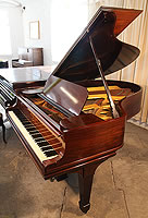 An unrestored, 1907, Steinway Model O grand piano with a mahogany case and spade legs 