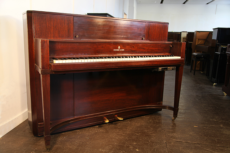 A 1940,  Steinway T691  upright piano with a polished, mahogany case
