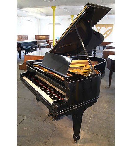 A 1928, Steinway Model O grand piano with a black case and spade legs