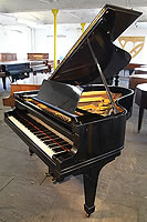 A 1928, Steinway Model O grand piano with a black case and spade legs 