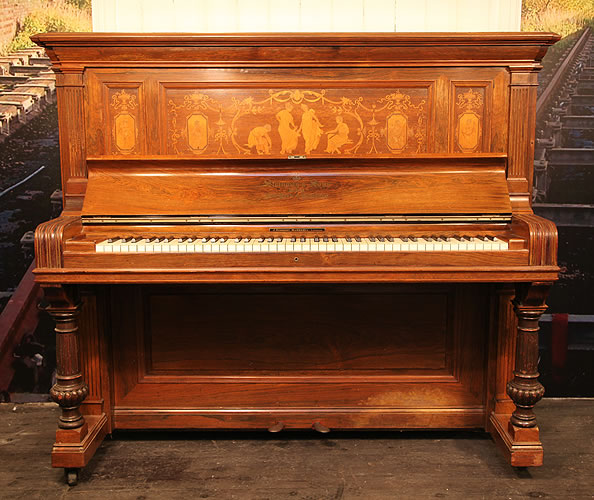 A preowned, 1894 Steinway  upright piano with a  rosewood case, inlaid with dancing ladies, cherubs and swags