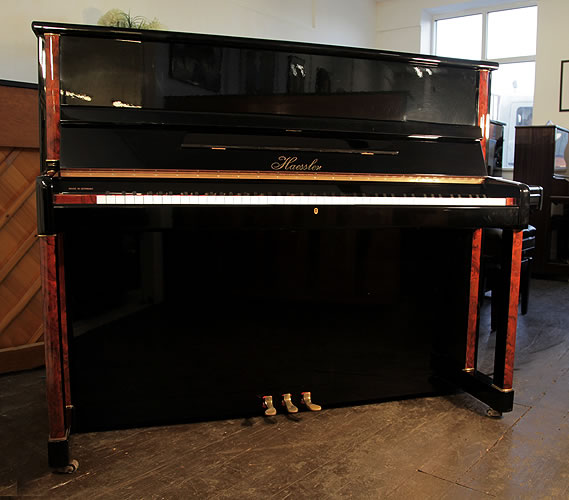 Haessler upright Piano for sale with a black case.