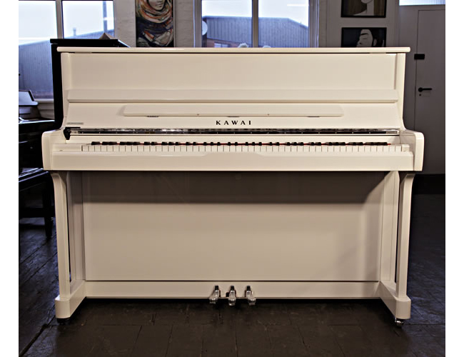 A new, Kawai K2 upright piano with a white case and polyester finish