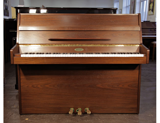 A Kemble upright piano with an American walnut case