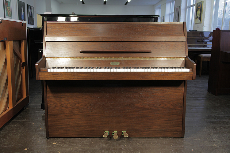 A Kemble upright piano with an American walnut case