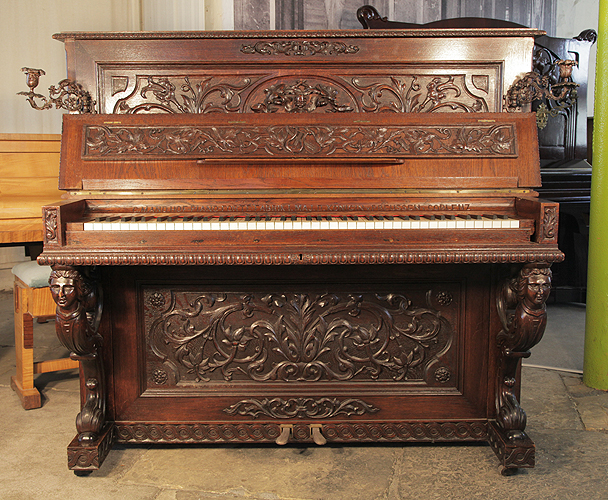 Piano for sale. A Mand Upright Piano with an Neoclassical Style Oak Case. Entire Cabinet is Covered with Ornate High Relief Carvings of Cherubs, Acanthus, Hibiscus and Caryatids supporting the keyboard