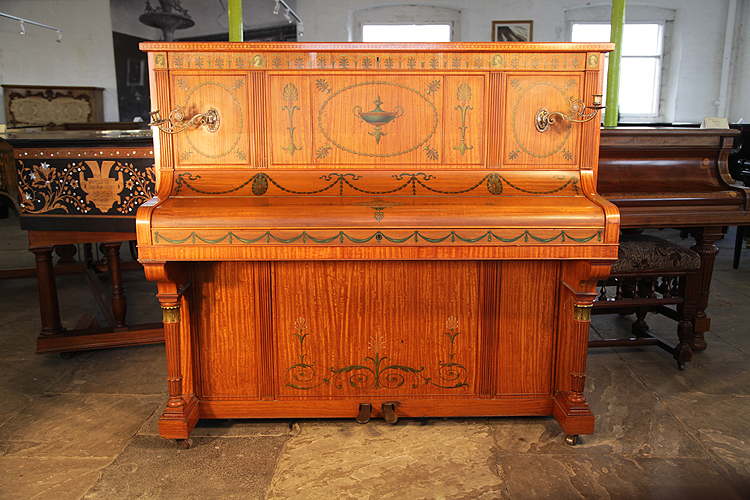  An art cased Otto upright piano with a satinwood case, beautifully hand-painted in a romanesque design with anthemions, cabuchons, swags and urns.