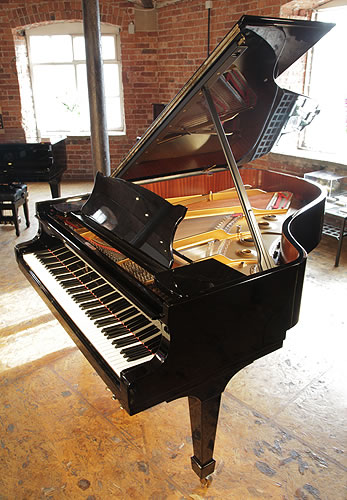 A 1999, Steinway Model A grand piano with a black case and spade legs
