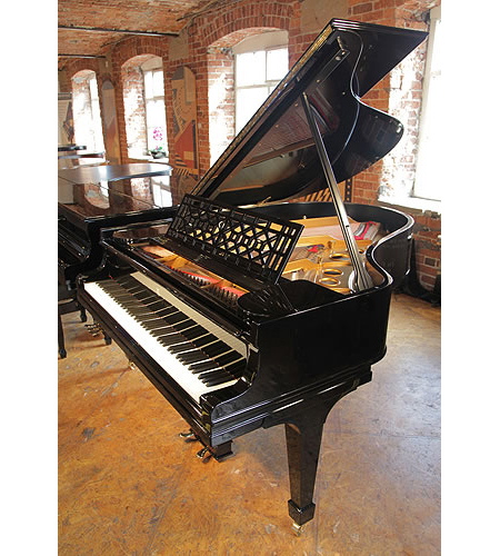 A rebuilt, 1911, Steinway Model O grand piano with a black case and spade legs
