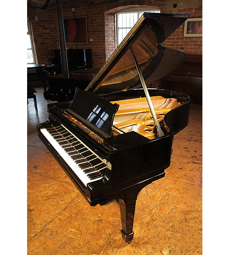 A 1923, Steinway Model O grand piano with a black case and spade legs