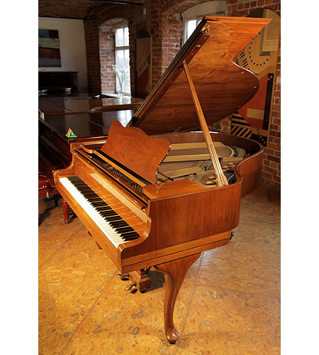 A 1938, Steinway Model S baby grand piano with a mirrored walnut case and cabriole legs