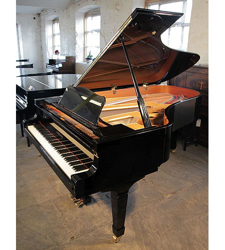 A 1990, Yamaha C3 grand piano for sale with a black case and spade legs