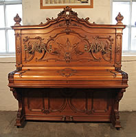 A Ludwig Adam upright piano with rococo style case, cabinet covered in ornate carvings with gilt detail