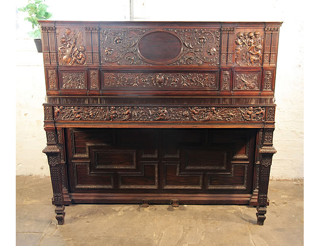An 1880, Broadwood upright piano with a Neo-Renaissance style, Rosewood case. Entire Cabinet is Covered with Ornate High Relief Carvings. 