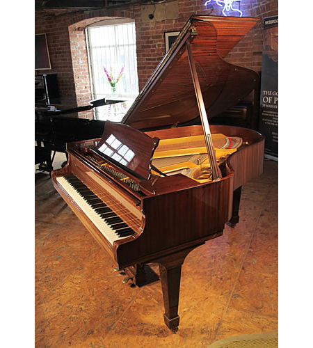 A 1970, Steinway Model M grand piano with a mahogany case and spade legs 