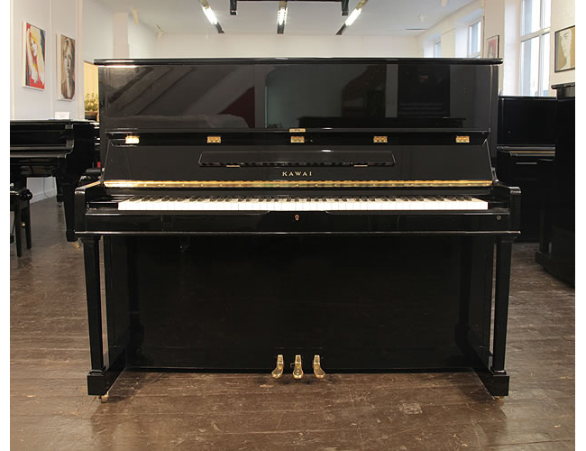 A 1989, Kawai CS-35N upright piano with a black case and polyester finish