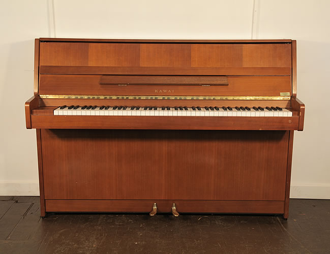 A 1987, Kawai CX-4S upright piano with a polished, mahogany case and brass fittings