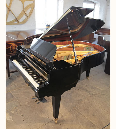 A 1965, Schimmel grand piano with a black case and tapered, square legs