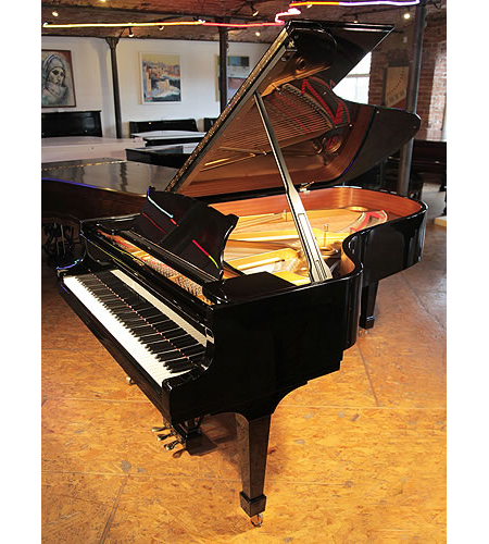 A 2004,  Steinway Model B grand piano with a black case and spade legs 