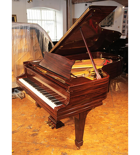A 1925, Steinway Model B grand piano with a fiddleback mahogany case and spade legs 