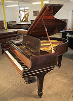 An unrestored, 1901, Steinway Model O grand piano with a rosewood case and spade legs.