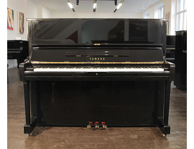 A secondhand, Yamaha U1 upright piano with a black case and polyester finish