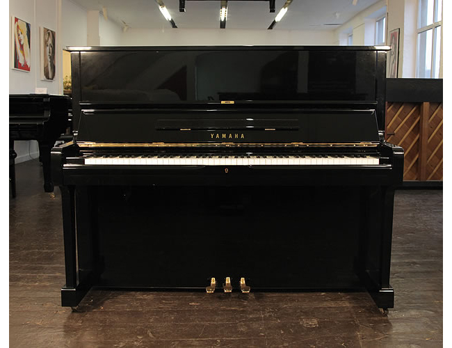 A 1975, Yamaha U1 upright piano with a black case and polyester finish