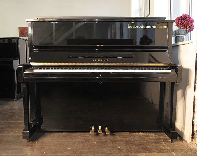 A 1986, Yamaha U1A upright piano with a black case and polyester finish