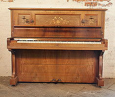 An antique, Bechstein model IV upright piano with a rosewood case and floral inlaid panels.