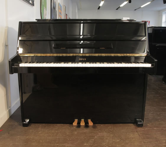 Opus upright Piano for sale with a black case.