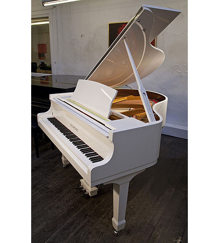 Brand new Steinhoven Model 148 baby grand piano with a white case and spade legs. Piano has an eighty-eight note keyboard and a three-pedal piano lyre.