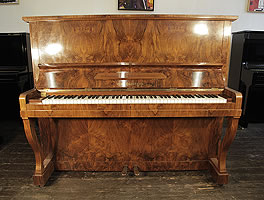 A 1943, Bechstein model 8 upright piano with a mirrored, walnut case