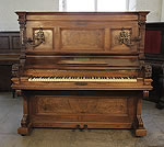 Piano for sale. Antique, Ehret upright piano with a walnut case. Cabinet features piano cheeks with carved lions heads