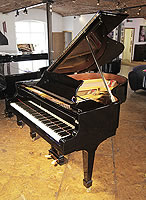 A rebuilt 1923, Steinway Model O grand piano with a black case and spade legs