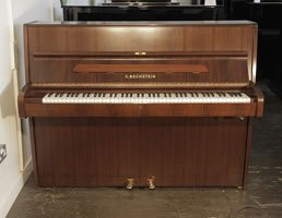 A 1988, Bechstein upright piano with a walnut case