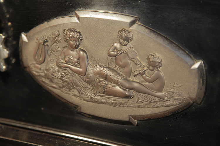 Bord plaque featuring a reclining lady and cherubs playing instruments