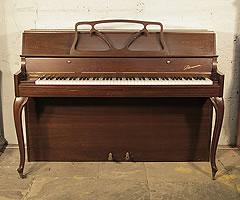 A 1980, Danemann console upright piano with a mahogany case and cabriole legs.