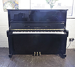 Piano for sale. A 1985, Kawai NS-10 upright piano with a black case and polyester finish