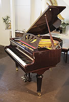 Piano for sale. A Lothar Schell baby grand piano with a mahogany case, cut-out music desk and turned legs