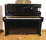 Piano for sale. A 1995, Steinway Model K upright piano with a black case and brass fittings. Piano has an eighty-eight note keyboard and two pedals 