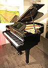 Piano for sale. A Yamaha G2 grand piano for sale with a black case and spade legs