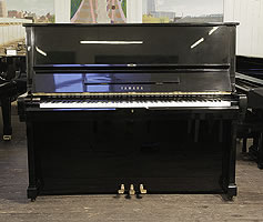 A 1973, Yamaha U2 upright piano with a black case and polyester finish